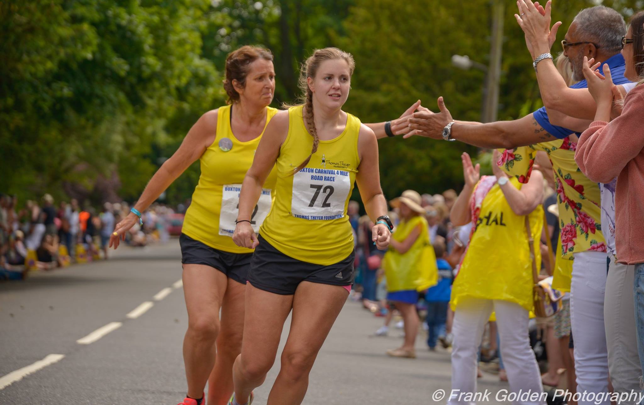 A runner racing through Buxton on Carnival Day