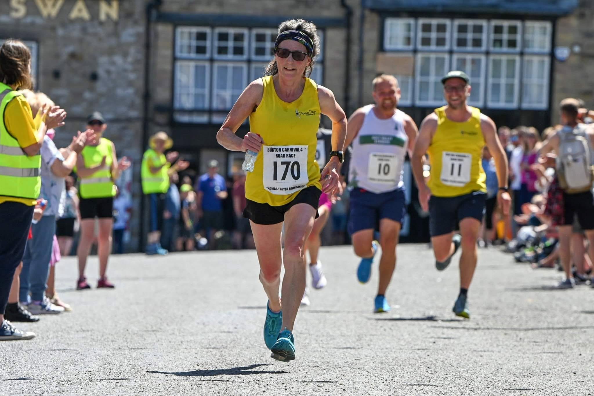 A runner approaching the finish through Carnival Day crowds