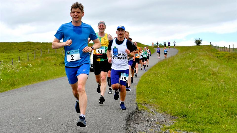 Runners crossing the open hills around Buxton