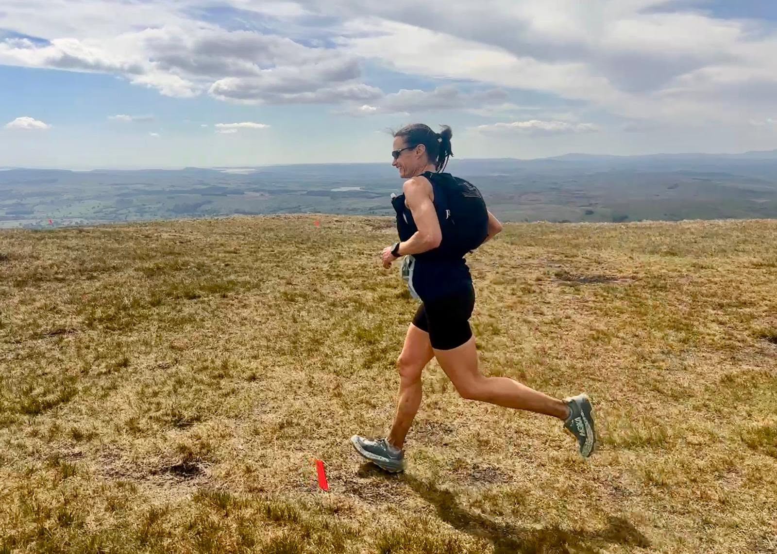 A Buxton AC runner racing across open moorland