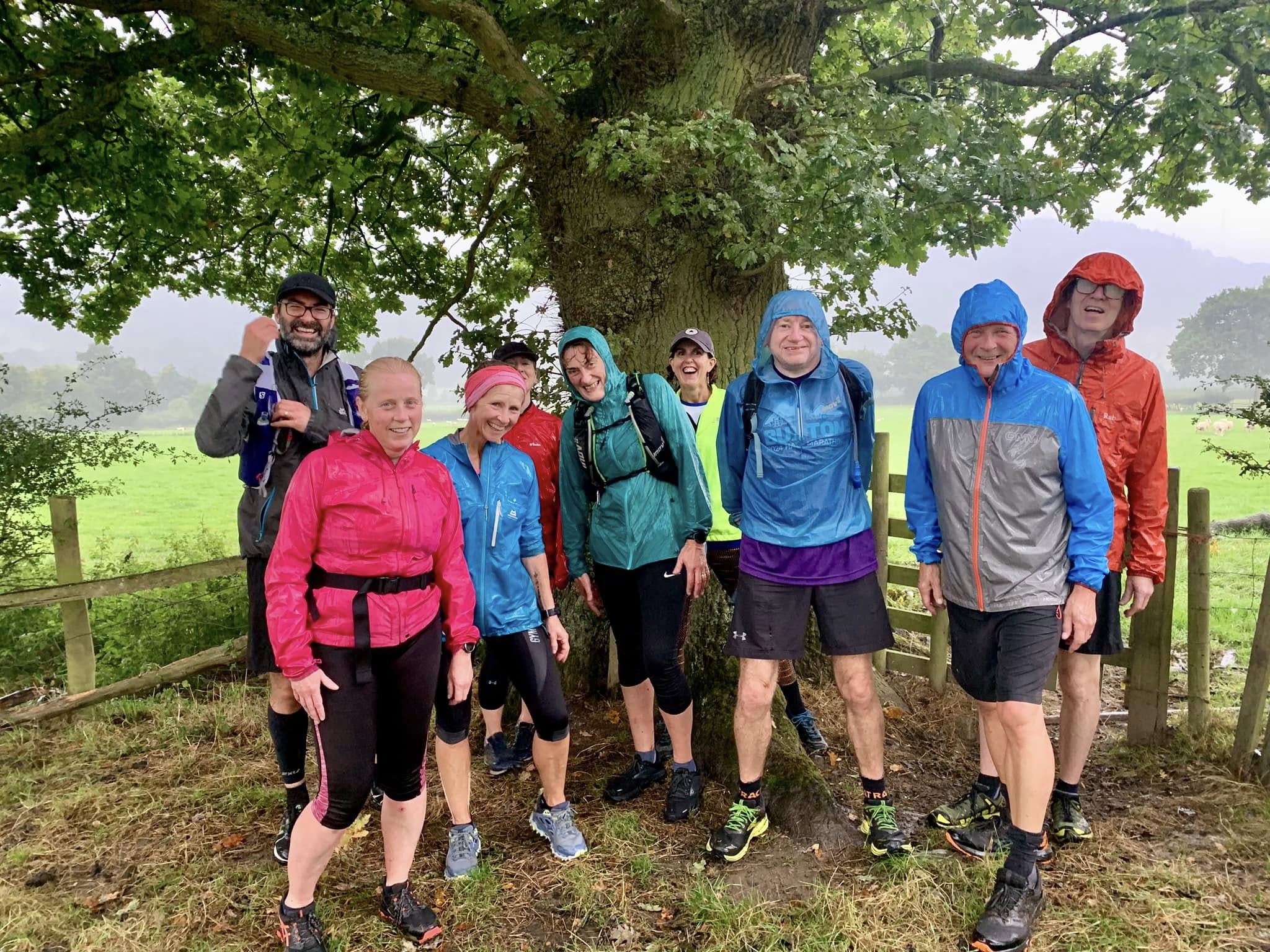 Club members smiling after a wet countryside run
